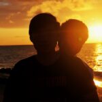 silhouette of man wearing sunglasses during sunset